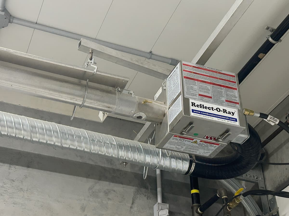 Reflect-O-Ray radiant heating unit with stainless steel burner and pre-heater intake duct.